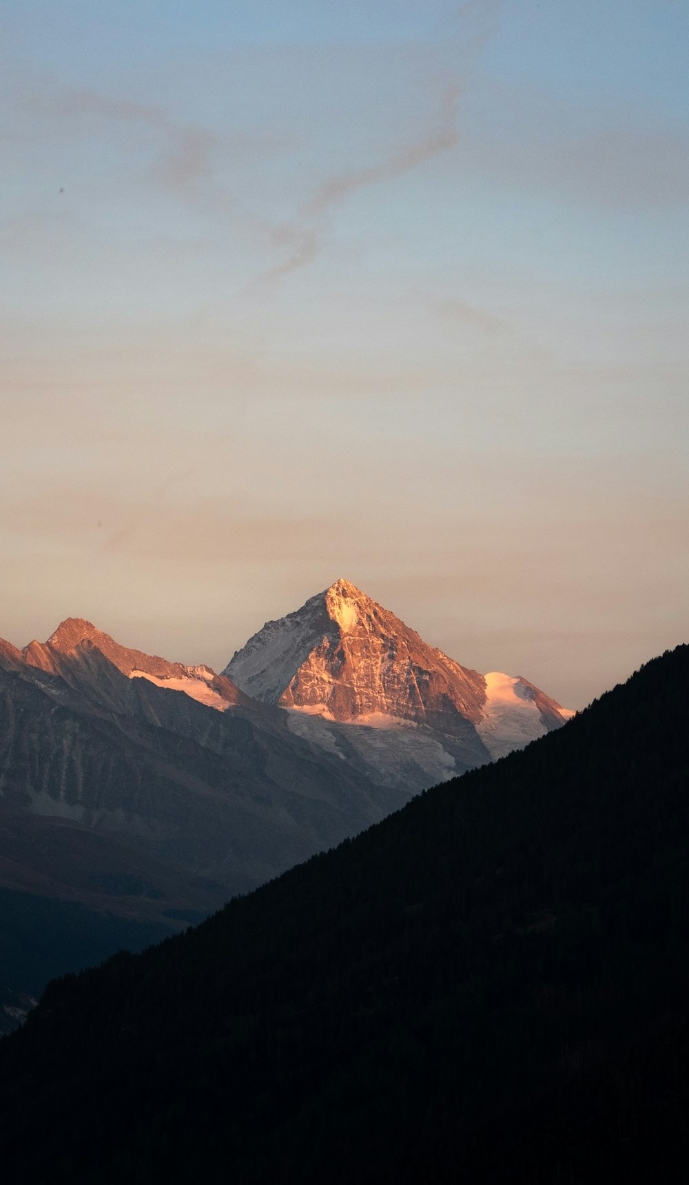 a view of a mountain at sunset from a distance