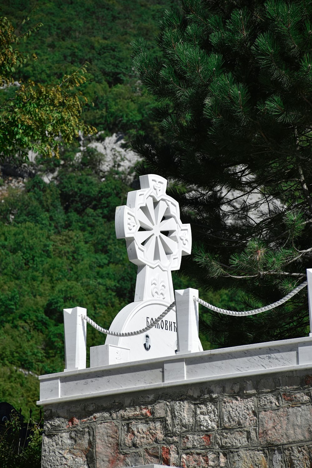 돌담 위에 있는 하얀 십자가