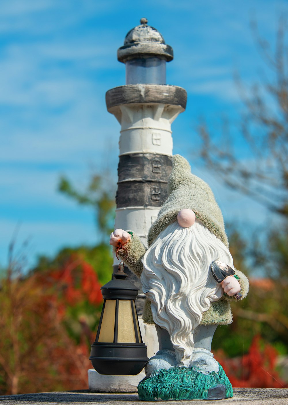 a statue of a gnome next to a light pole
