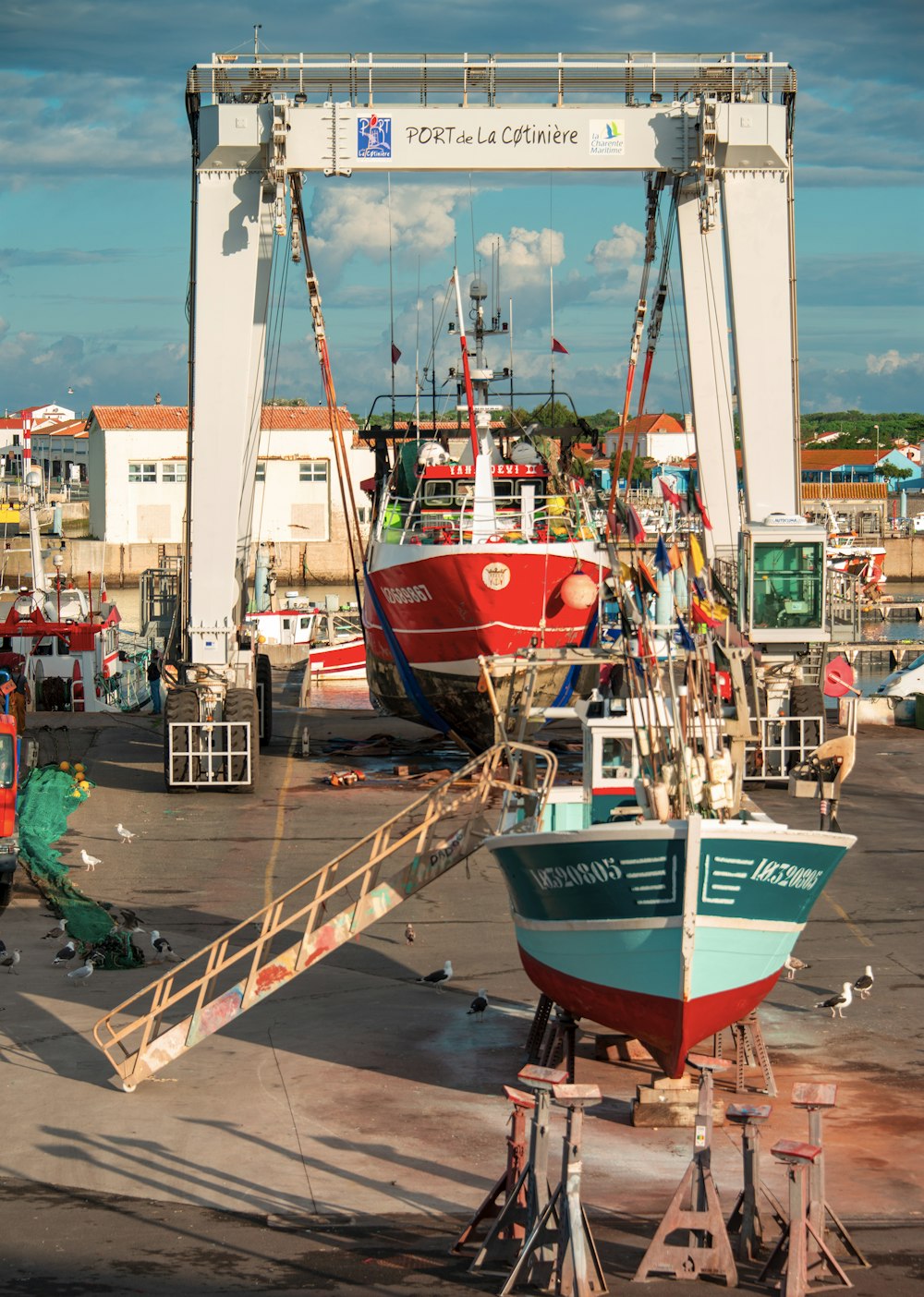 a red and white boat sitting on top of a tarmac