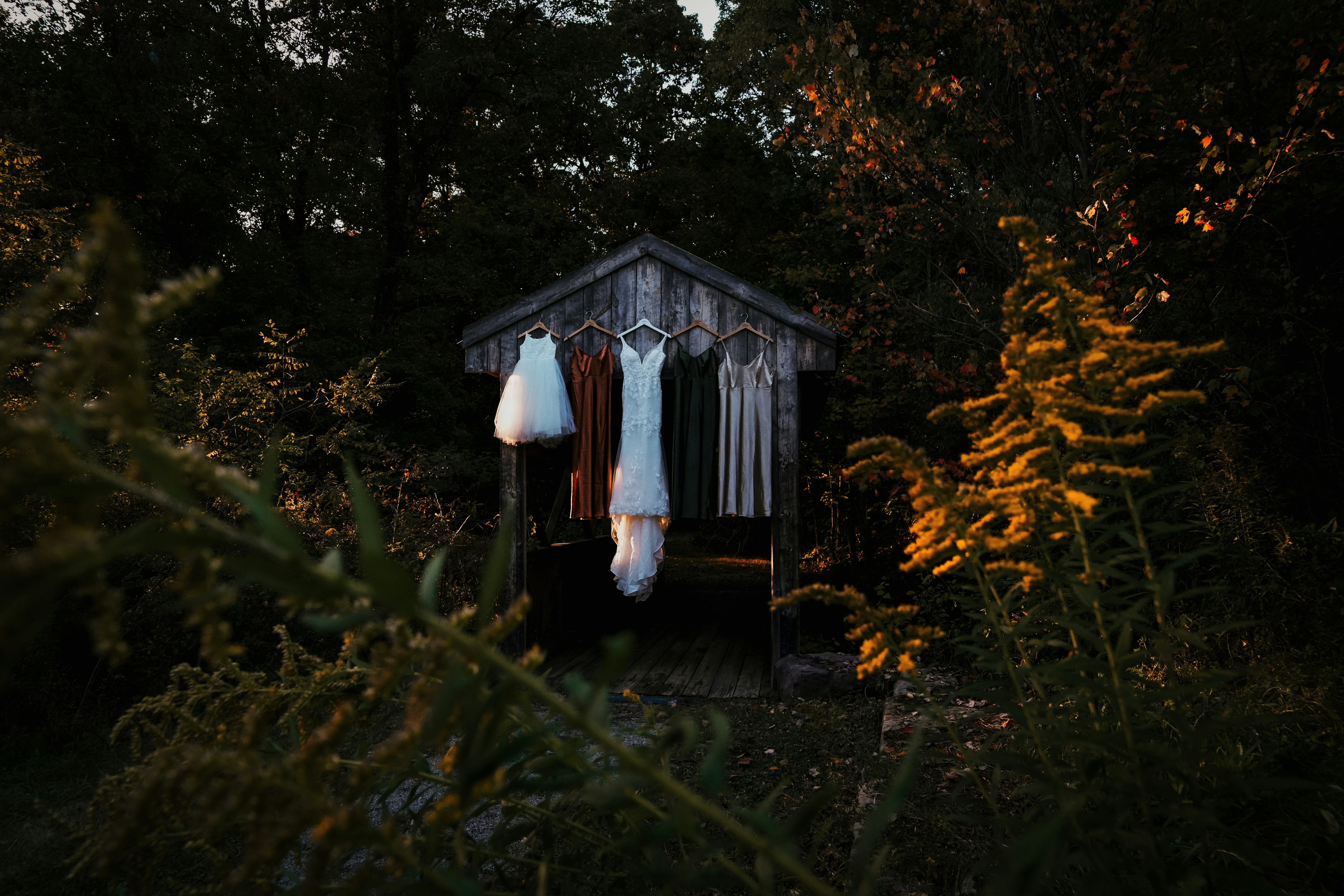 a wooden shed with clothes hanging on it