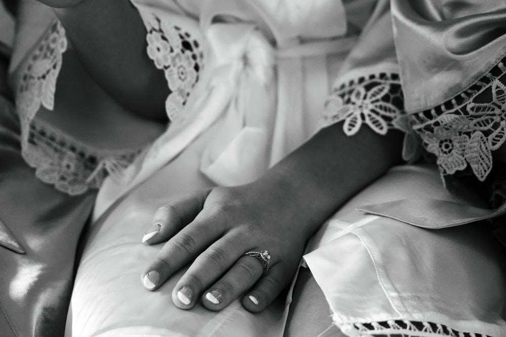 a woman's hand with a ring on her finger