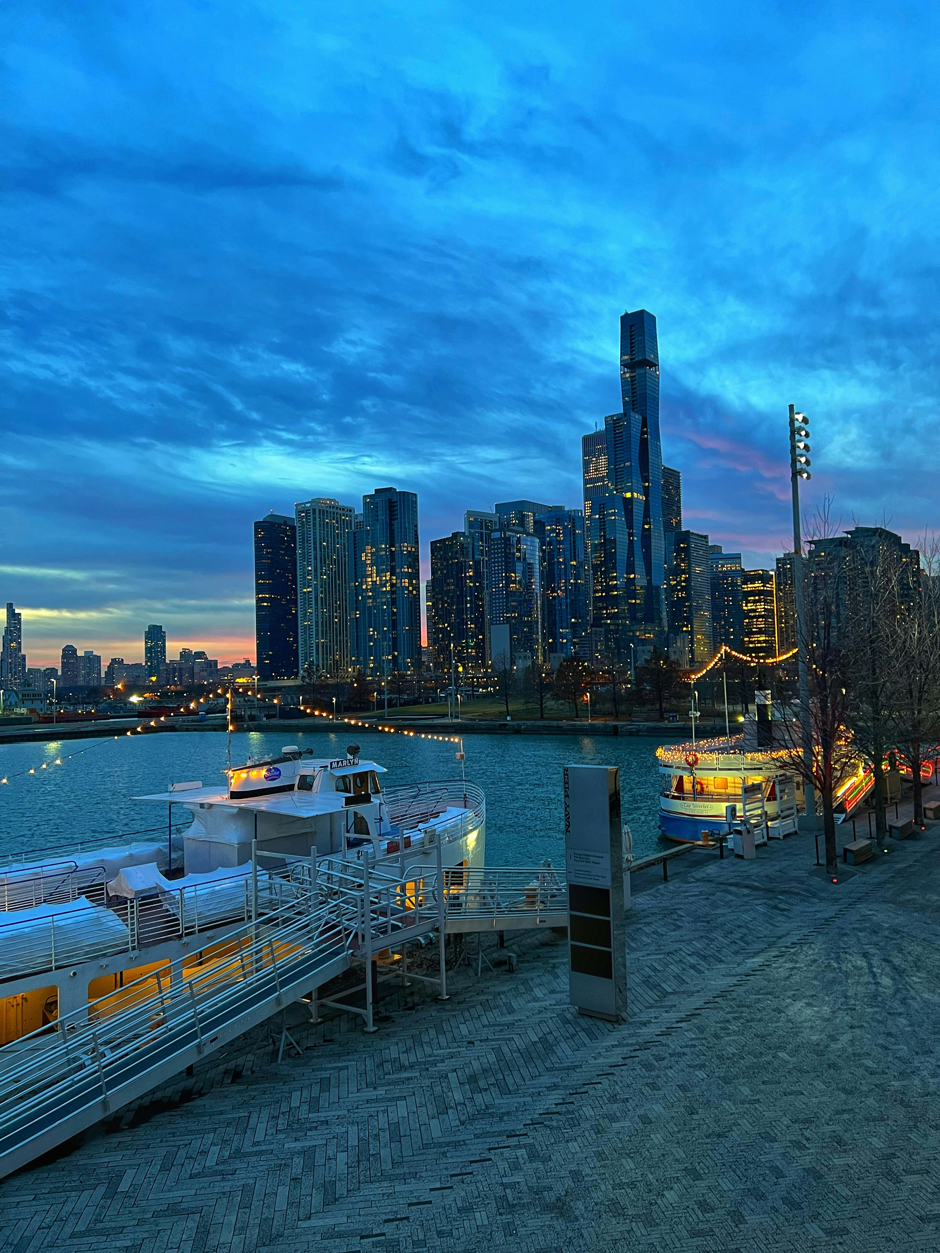 a city skyline with a body of water in the foreground