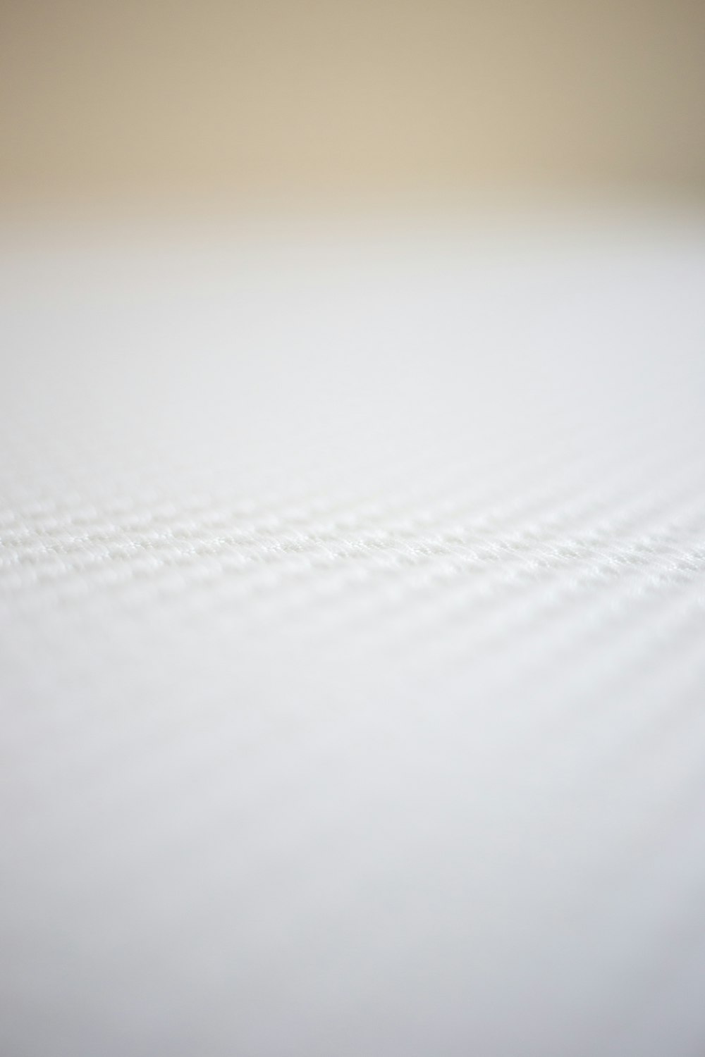 a close up view of a mattress with white sheets