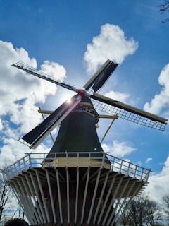 a windmill with the sun shining behind it