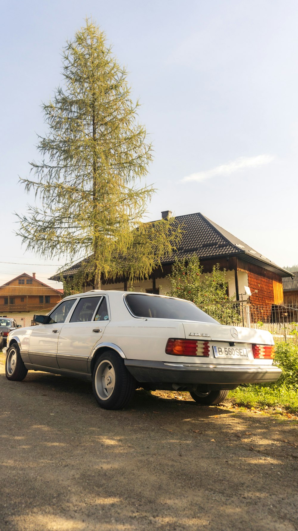 a white car parked in front of a house