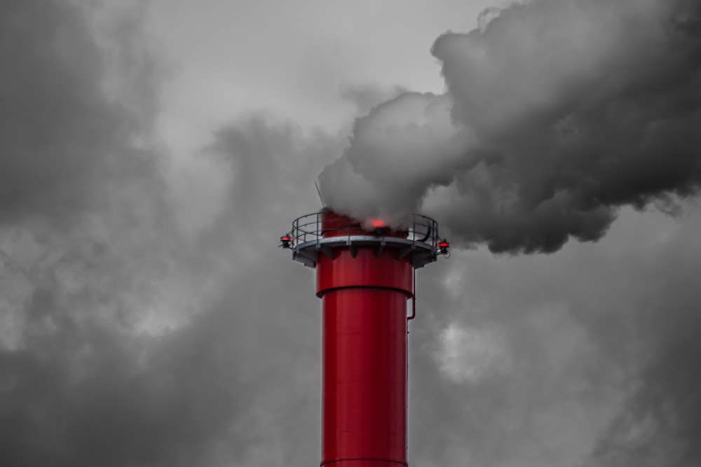 a red tower with smoke coming out of it