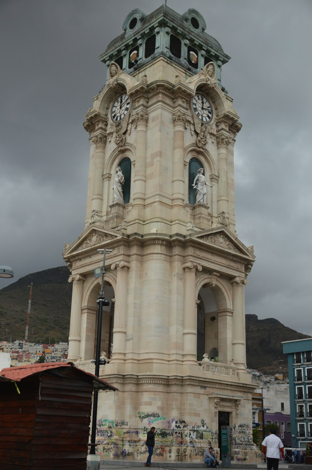 a tall clock tower with a clock on each of it's sides