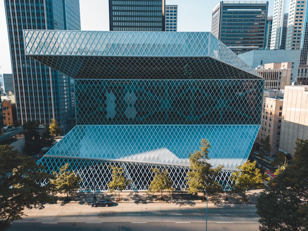 an aerial view of a building with a large pool in front of it