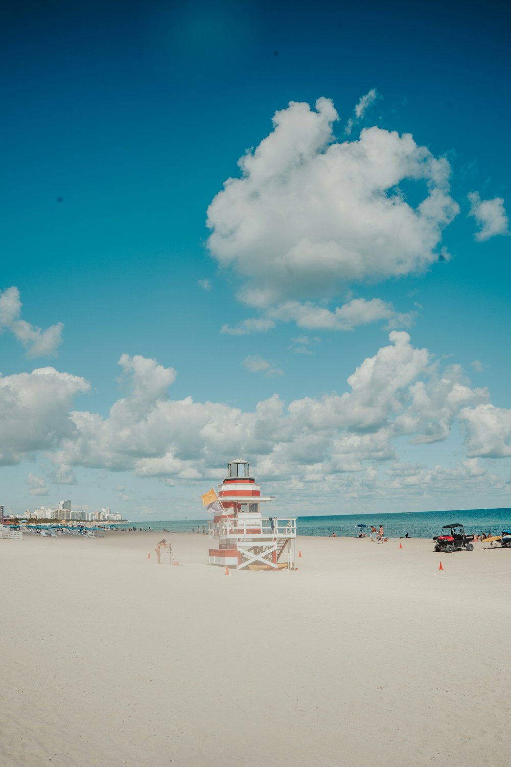 a lifeguard tower on a beach with a sky background