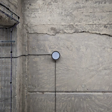 Close-up of moisture detection equipment on a wall inside a modern apartment.
