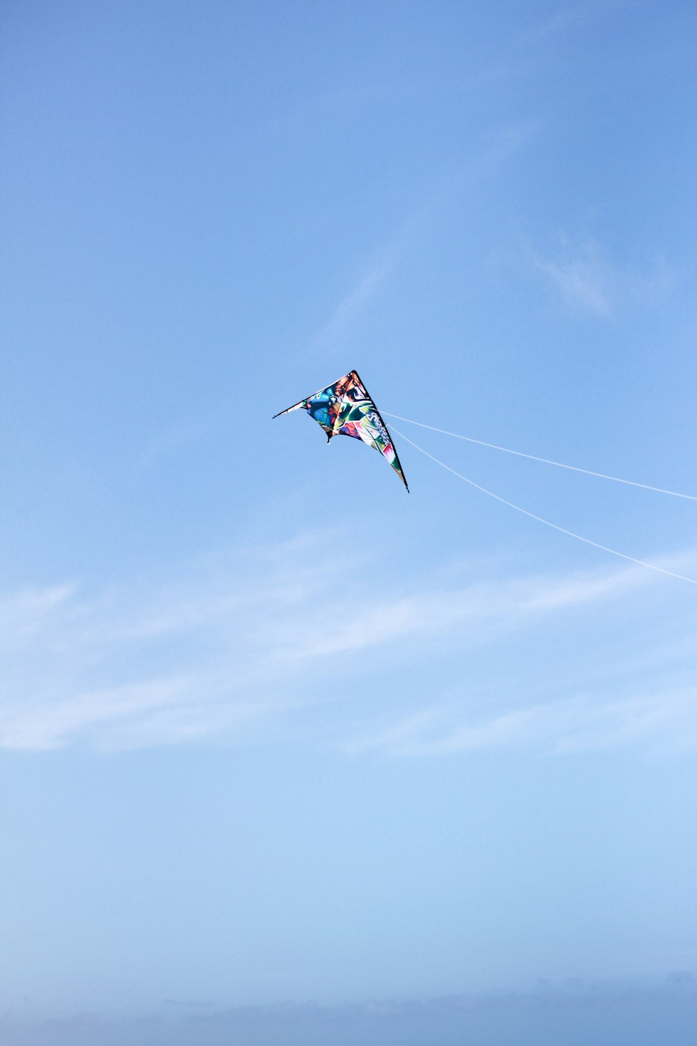 a person flying a kite on the beach
