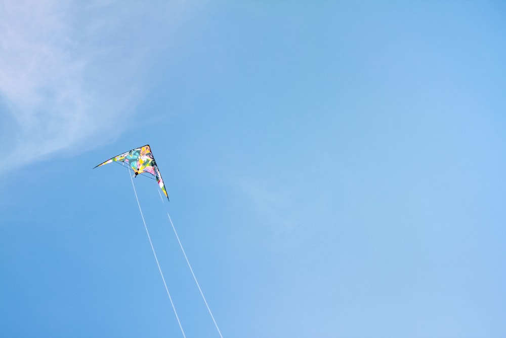a kite flying high in the blue sky