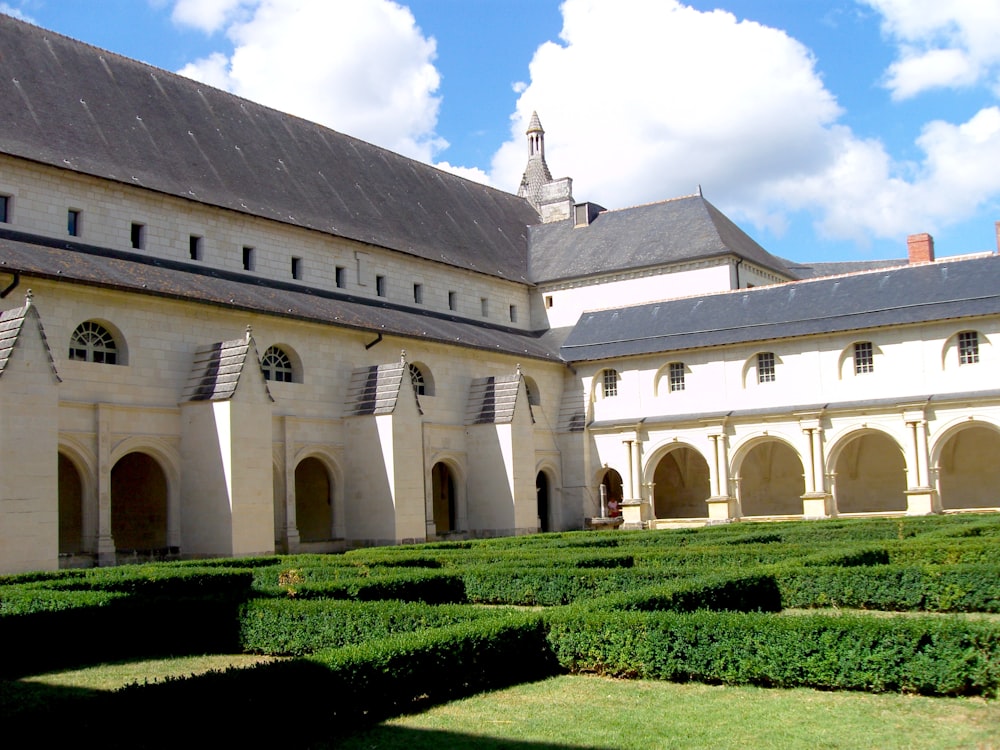 a large building with a large garden in front of it