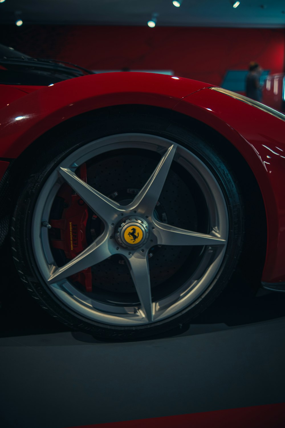 a close up of a red sports car on display