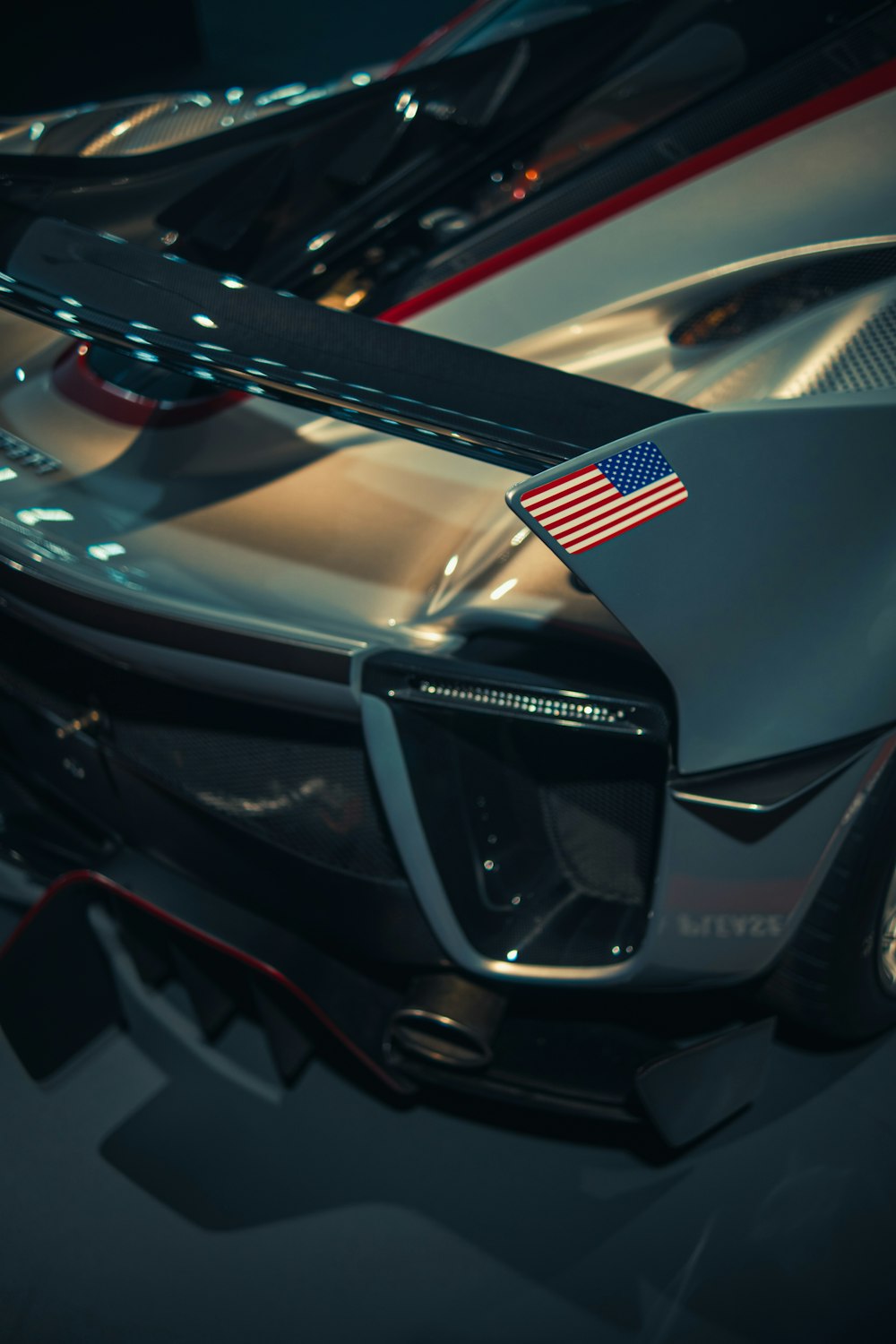 a close up of a sports car with an american flag on it