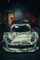 Race-inspired shop interior with carbon black walls and neon green telemetry overlays glowing softly.