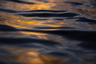 A peaceful meditation circle bathed in warm golden light, surrounded by gentle navy and crème hues reflecting calm.