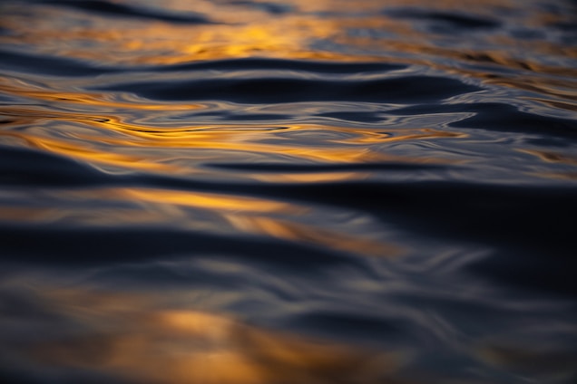 A peaceful meditation circle bathed in warm golden light, surrounded by gentle navy and crème hues reflecting calm.