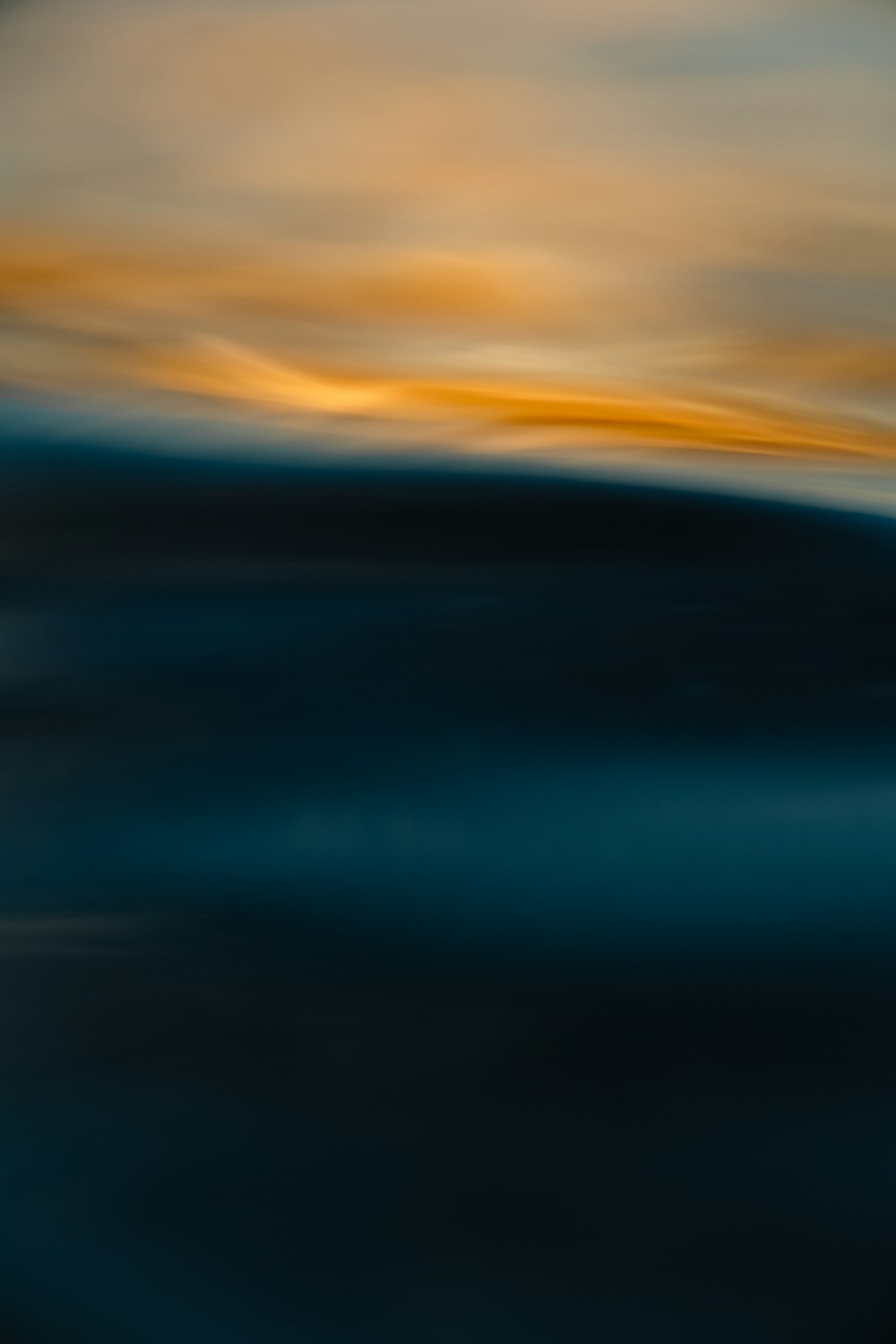 a blurry photo of the ocean at sunset