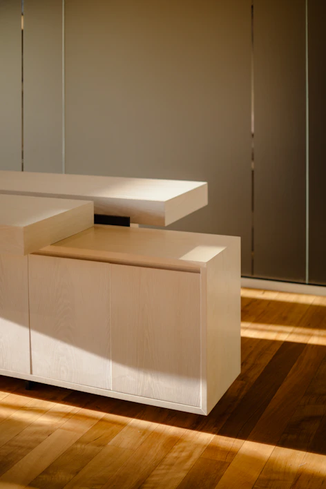 A sleek modern luxury side cabinet with clean lines and a warm wood finish.