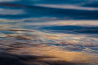 A softly lit art print featuring gentle waves of muted blues and greys, evoking a serene ambient soundscape.