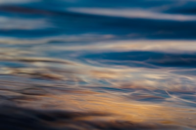 A softly lit art print featuring gentle waves of muted blues and greys, evoking a serene ambient soundscape.