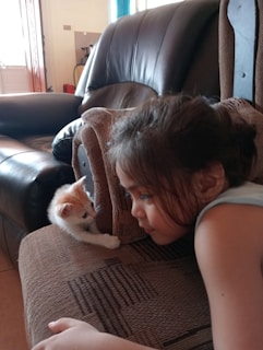 Koda sitting beside a child, showcasing their bond.