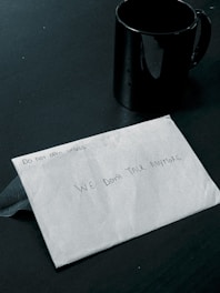 A sealed envelope labeled 'Confidential' resting on a wooden desk.