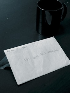 A sealed envelope labeled 'Confidential' resting on a wooden desk.