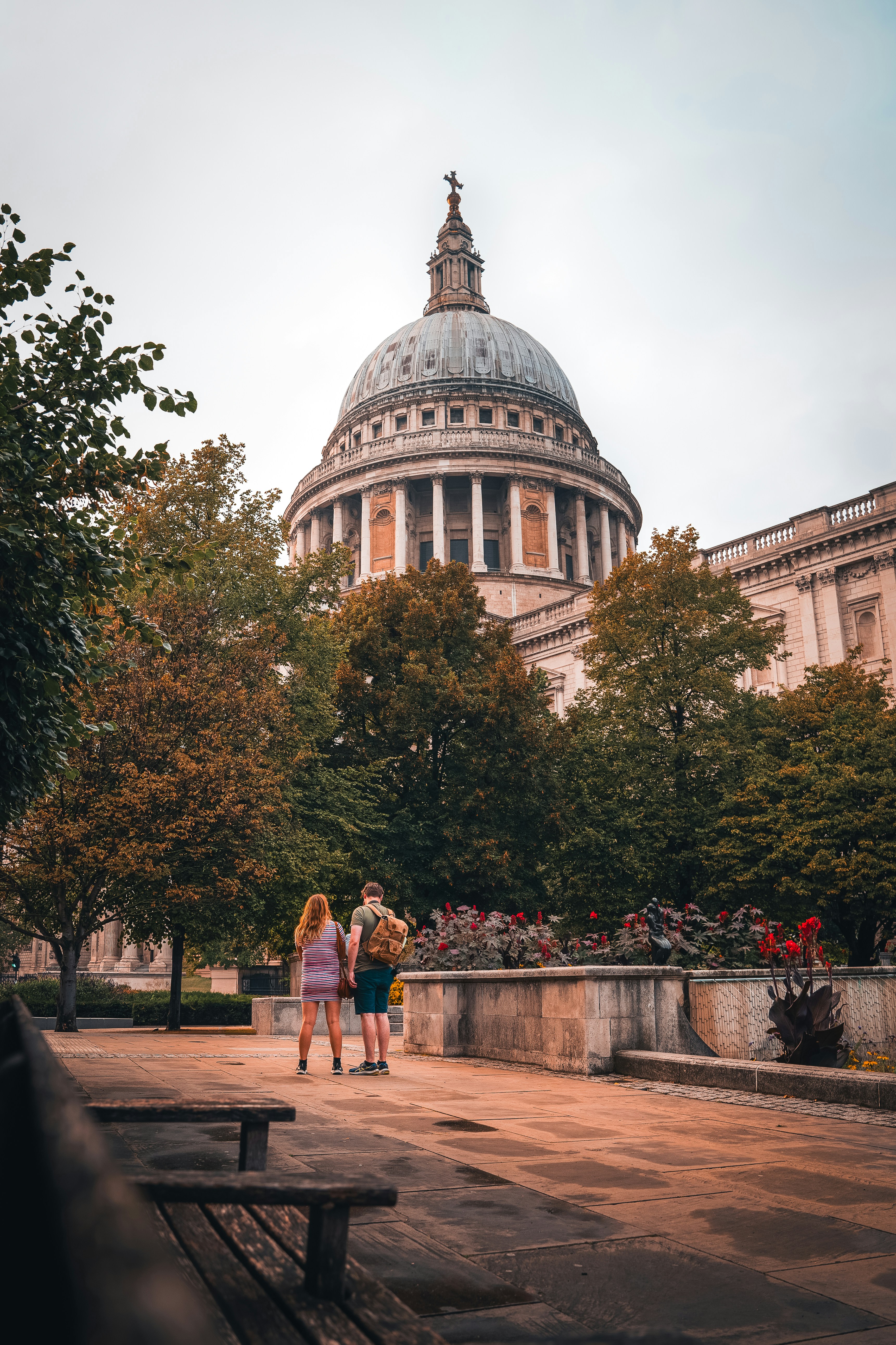 two girls are standing in front of a domed building