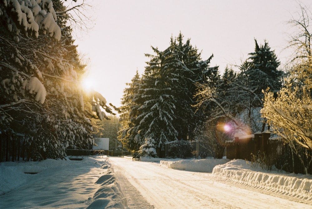 a person riding a snowboard down a snow covered road