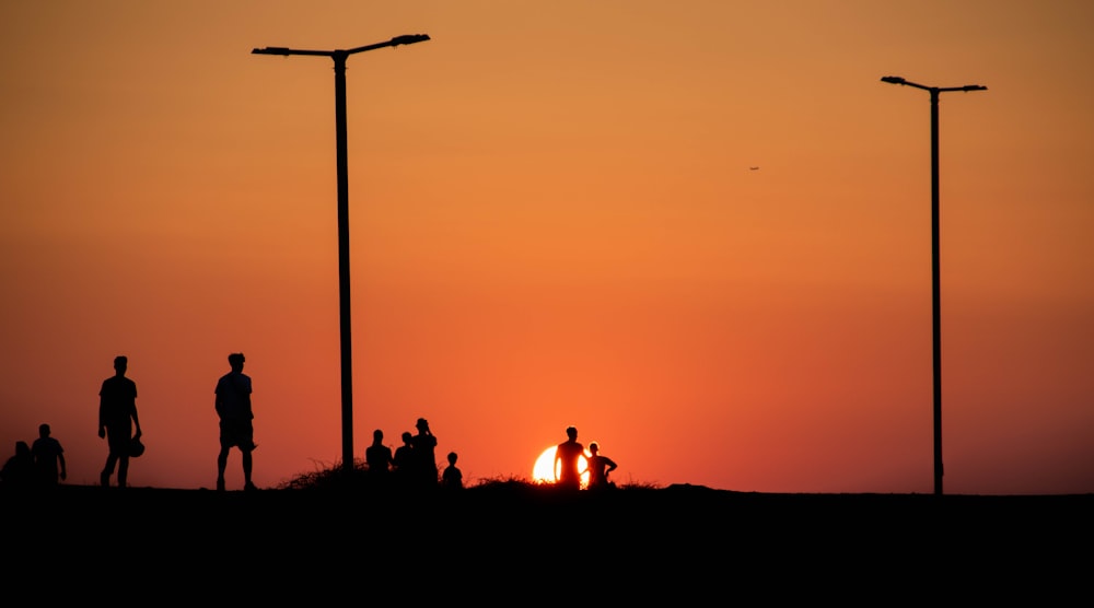 a group of people standing on top of a hill