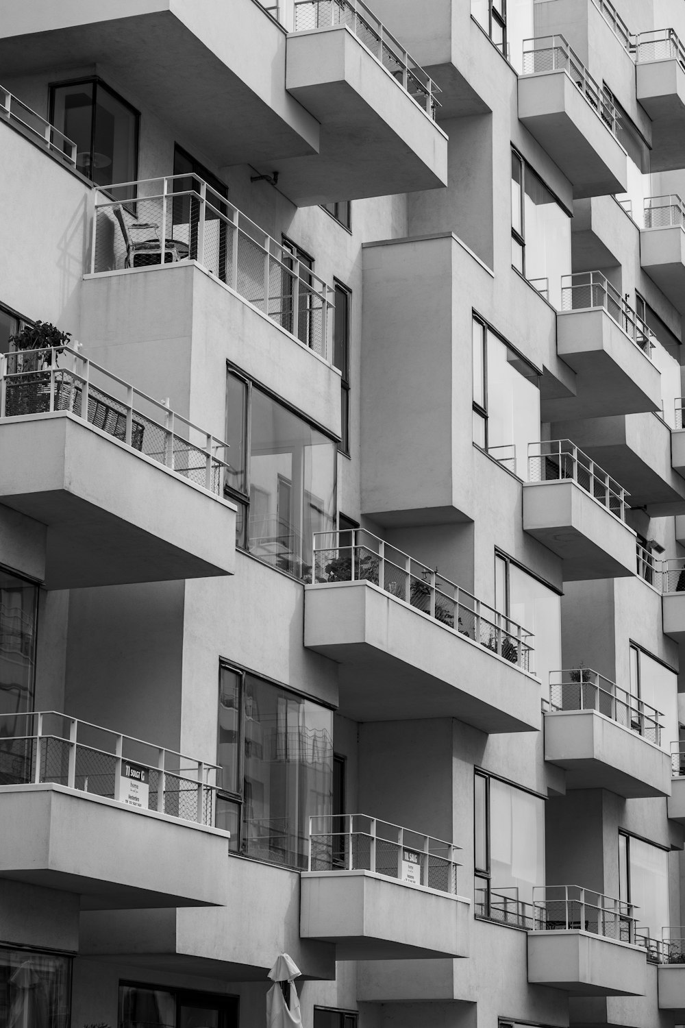 a black and white photo of a building with balconies