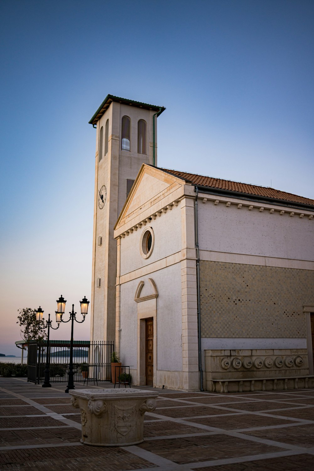 a tall white building with a clock on it's side