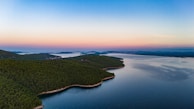 An aerial view of the Pacific Northwest coastline at dawn, connecting nature with our programming spirit.