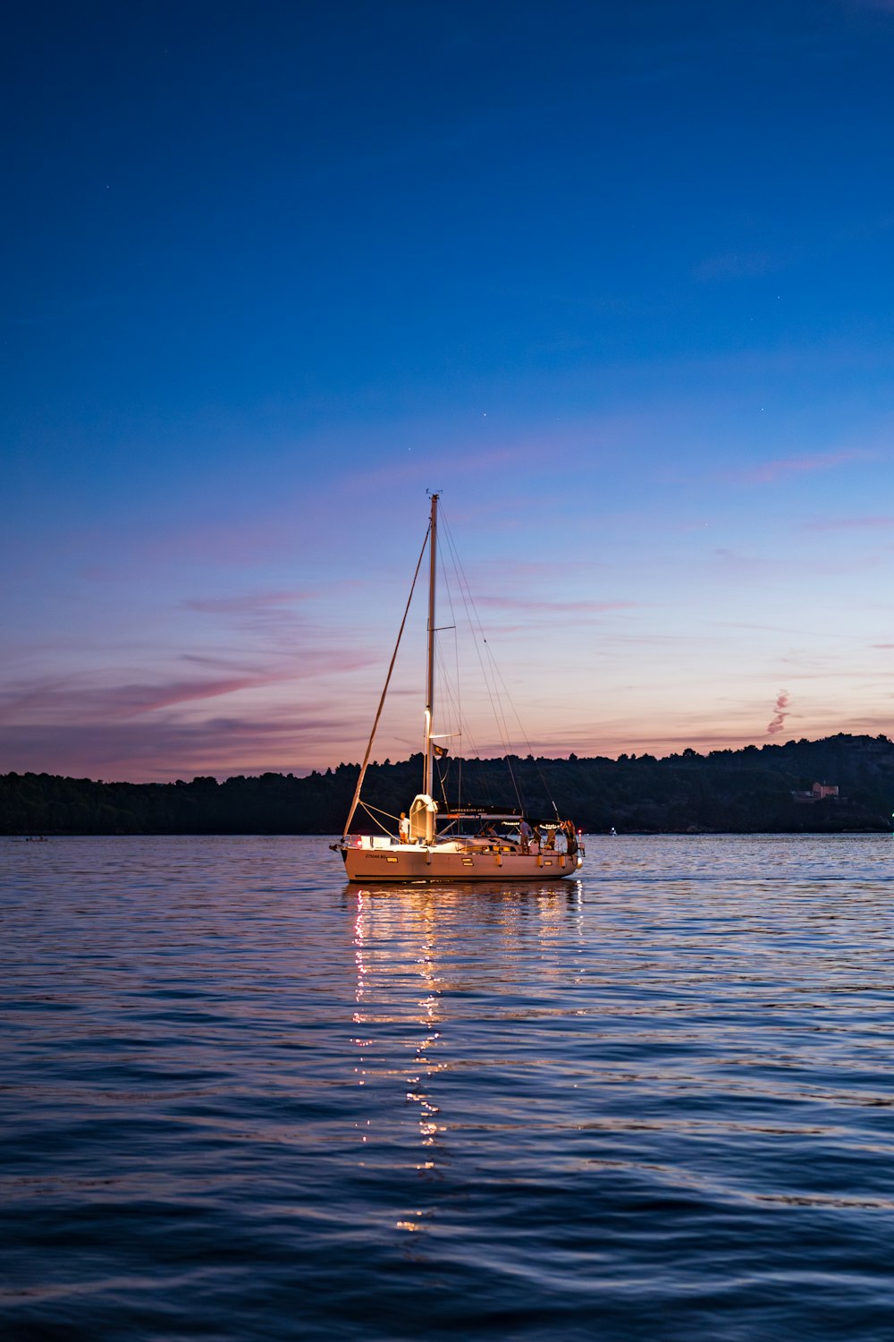 a sailboat floating on top of a large body of water