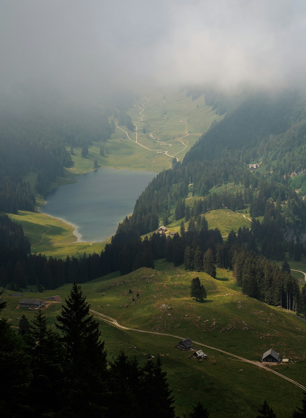 a view of a valley with a lake in the middle