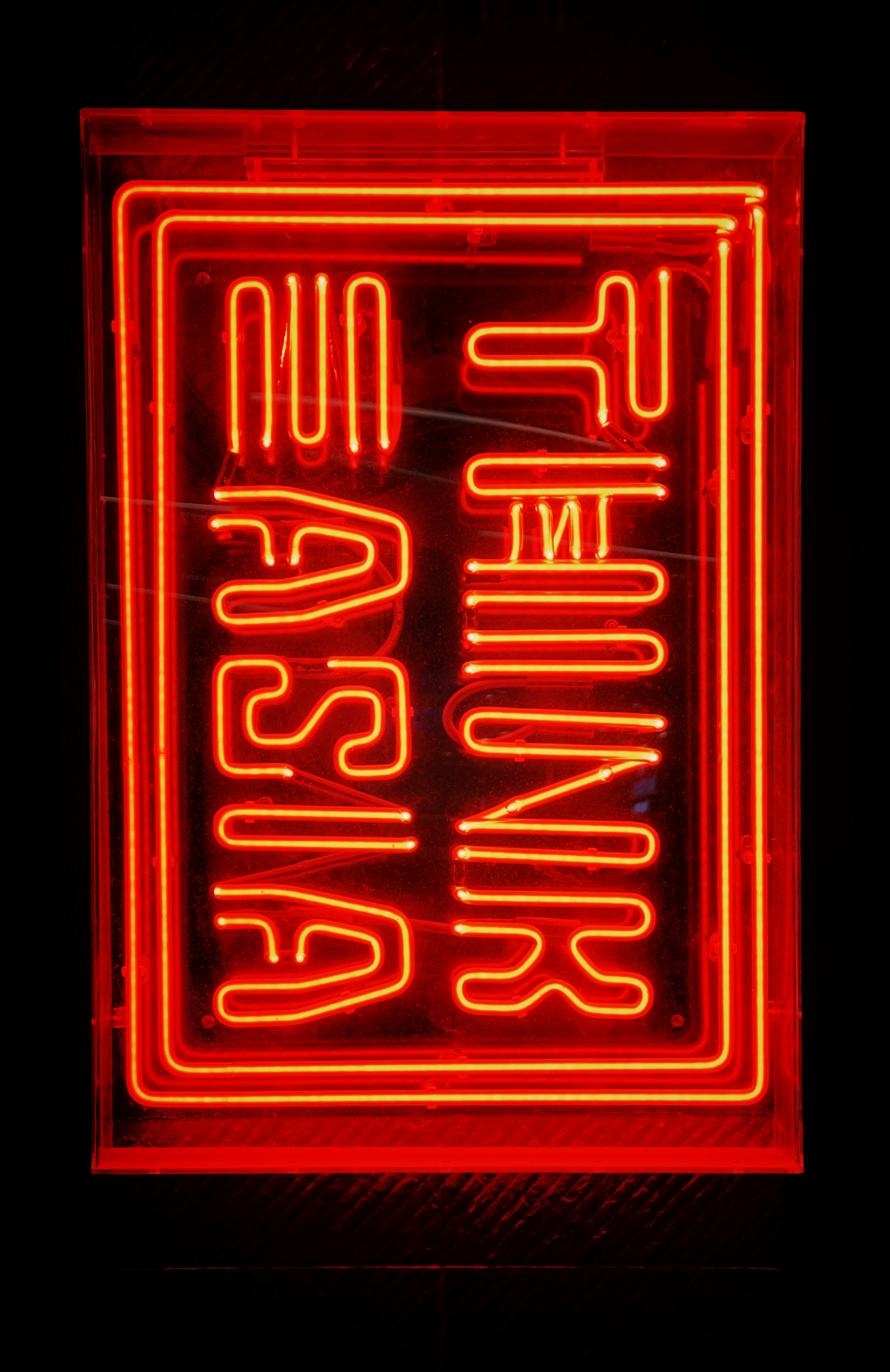 a red neon sign that says no parking