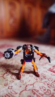 Close-up of a colorful 3D printed toy robot on a wooden table