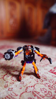 A vibrant close-up of a colorful robotic toy designed for children, glowing softly against a sleek modern background.
