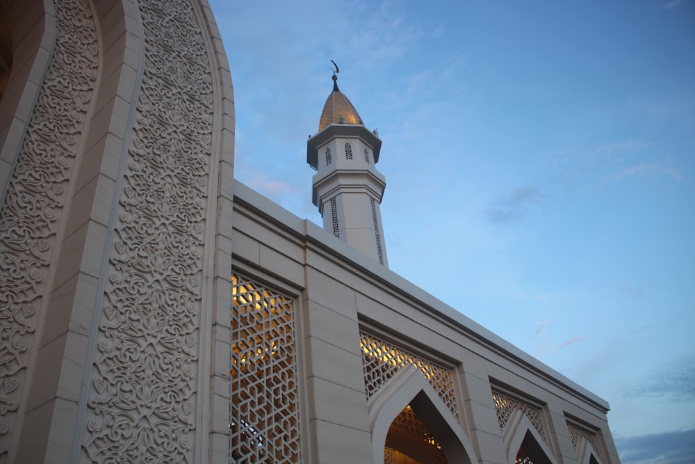 a tall white building with a clock tower