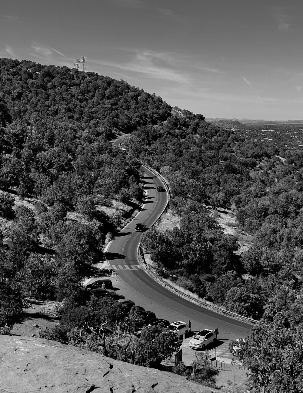 a black and white photo of a winding road