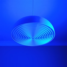 a circular light fixture in a blue room