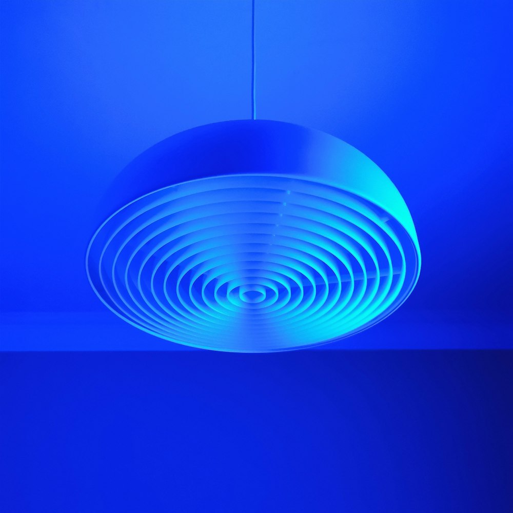 a circular light fixture in a blue room