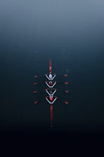 a row of boats floating on top of a body of water