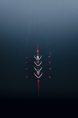 a row of boats floating on top of a body of water