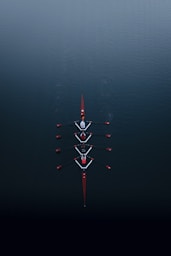 a row of boats floating on top of a body of water