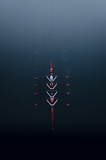a row of boats floating on top of a body of water