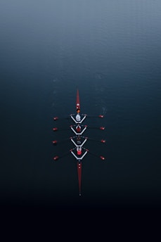 a row of boats floating on top of a body of water